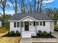 Charming renovated home with a white exterior, gray roof, and landscaped yard at 409 Jones S Ave, Rock Hill, SC 29730
