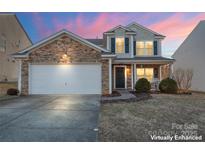 Two-story house with stone accents and a two-car garage at 9321 Bayview Pkwy, Charlotte, NC 28216
