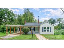 Charming white bungalow with covered carport and landscaped yard at 123 Lincoln St, Statesville, NC 28677