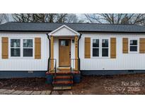 Newly renovated house featuring white siding, a brown door, and stylish shutters at 1940 33Rd Ne Ave, Hickory, NC 28601