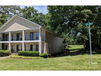 Inviting townhouse showcasing a quaint balcony and neat landscaping enhancing its curb appeal at 1985 Lancer Ct, Gastonia, NC 28054