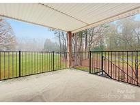 Private patio with black railing, overlooking grassy area at 1985 Lancer Ct, Gastonia, NC 28054