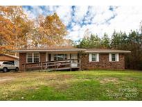 A charming one-story brick home featuring a well-maintained front yard and a convenient wheelchair ramp at 2485 Nc Highway 109 S Hwy, Mount Gilead, NC 27306