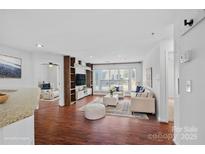 Spacious living room with hardwood floors and built-in shelving at 513 N Graham St # 1B, Charlotte, NC 28202