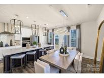 Modern kitchen with island, stainless steel appliances, and white cabinetry at 134 Judson Ave, Charlotte, NC 28208