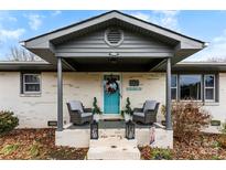 Charming ranch home with gray roof and teal front door at 1535 Rolling Meadow Ln, Gastonia, NC 28054