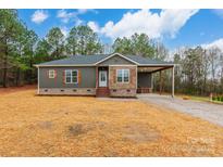 New construction home features gray siding, stone accents, and a covered porch at 2434 Wo Gladden Rd, Chester, SC 29706