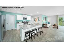 Modern kitchen with island, stainless steel appliances, and granite countertops at 1018 Hostler Ln, York, SC 29745