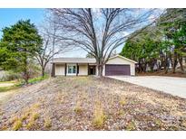 Tan one-story house with brown garage door and covered porch at 11015 Vista Haven Dr, Charlotte, NC 28226