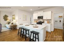 Modern kitchen with island, stainless steel appliances, and white cabinets at 202 Brinkley Dr # 11, Kings Mountain, NC 28086