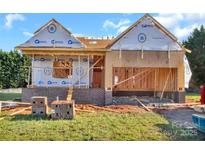 Image of new construction featuring brick accents, house wrap, and an attached two-car garage with wood framing at 244 Little Wilkesboro Rd, Harmony, NC 28634