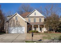 Two-story brick home with a large front yard and a two-car garage at 3529 Cameron Creek Dr, Matthews, NC 28105