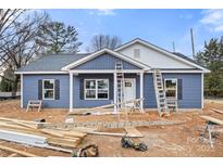 Newly constructed home with blue siding, white trim, and well-lit windows on a sunny day at 2365 28Th Ne St, Hickory, NC 28601