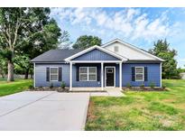 Charming blue single-story home with a well-manicured lawn and a freshly paved driveway at 2365 28Th Ne St, Hickory, NC 28601