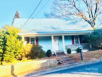 Light blue house with metal roof and mature trees at 510 Austin St, Albemarle, NC 28001
