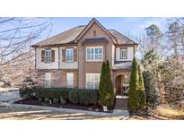 Two-story brick home with a large front yard and mature trees at 6928 Garden Hill Dr, Huntersville, NC 28078