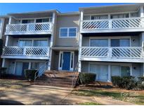 Two-story building exterior with blue door and multiple balconies at 9401 Old Concord Rd # K, Charlotte, NC 28213