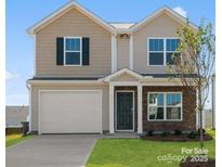 Two-story house with beige vinyl siding, a two-car garage, and landscaping at 1029 20Th Avenue Se Loop, Hickory, NC 28602