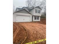 Two-story house with gray siding, attached garage, and a newly landscaped yard at 104 Springdale St, Shelby, NC 28150