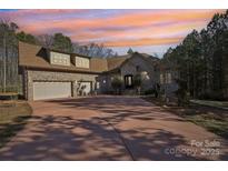 Brick house with three-car garage and large driveway at 10606 Williams Rd, Mint Hill, NC 28227