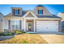 Two-story house with stone accents and a two-car garage at 242 White Apple Way, Statesville, NC 28625