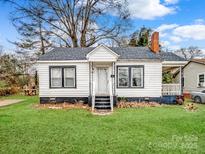 Charming white house with a grassy yard and mature trees at 415 Highland Ave, Shelby, NC 28150