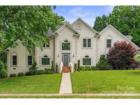 Beautiful two-story home features a well-manicured lawn, mature trees, and a grand entrance with meticulously maintained landscaping at 430 43Rd Nw Ave, Hickory, NC 28601