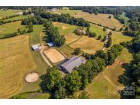 Aerial view of expansive horse property with barns, fields, and serene surroundings at 795 French Belk Rd, Mt Ulla, NC 28125