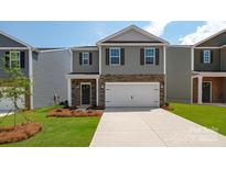 Two-story house with gray siding, stone accents, and a two-car garage at 1024 20Th Avenue Se Way, Hickory, NC 28602