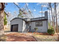 Gray house with dark brown garage door and steps leading to the front entrance at 1061 Woodlake Ln, Tega Cay, SC 29708