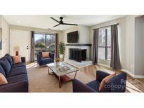 Bright living room features a fireplace, hardwood floors, and ample natural light at 8103 Cedar Glen Dr, Charlotte, NC 28212