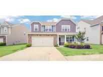 Two-story house with stone accents and a landscaped front yard at 8219 Pamplin Ct, Charlotte, NC 28273