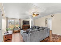 Spacious living room with a comfortable couch and large windows offering natural light at 980 Bear Poplar Rd, Cleveland, NC 27013