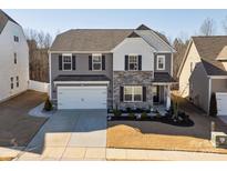 Two-story house with gray siding, stone accents, and a two-car garage at 1653 Loggerhead Dr, Lancaster, SC 29720