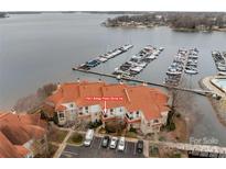 Stunning aerial view of waterfront condos with boat slips and ample parking, offering convenient lake access and scenic beauty at 17931 Kings Point Dr # G, Cornelius, NC 28031