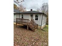 Newly renovated gray house with a wooden deck and steps at 1905 Circle Dr, Kannapolis, NC 28081