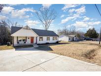 Newly renovated craftsman style home with a large driveway and mature trees at 2404 Datsun Ave, Concord, NC 28027