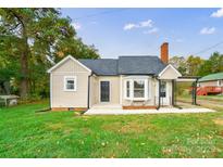 Tan house with gray roof, landscaping, and a spacious yard at 2500 S Ridge Ave, Kannapolis, NC 28083