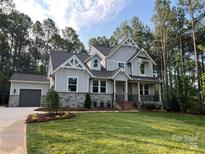 Craftsman home featuring a two-car garage, covered porch, beautiful lawn and professional landscaping at 5053 Townsend Rd, Lancaster, SC 29720