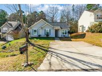 Gray house with gray shutters, landscaping, and a paved driveway at 842 Wilcrest Ct, York, SC 29745