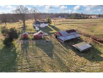 Aerial view of a house, barn, and other outbuildings on a large property at 956 Stony Point Rd, Kings Mountain, NC 28086