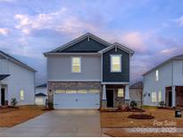 Two-story house with gray and beige siding, a white garage door, and landscaping at 1334 31St St # 6, Conover, NC 28613