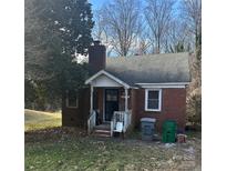 Brick home with front porch and yard at 6701 Rockwell W Blvd, Charlotte, NC 28269