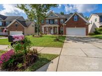 Brick two-story house with attached garage and landscaped lawn at 8505 Delamere Ln, Charlotte, NC 28269