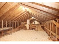Unfinished attic space with wood beams and flooring at 936 23Rd Ne Ave, Hickory, NC 28601
