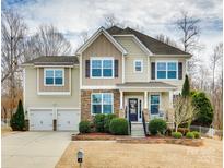 Two-story house with stone accents and a two-car garage at 1004 Damson Ln, Waxhaw, NC 28173