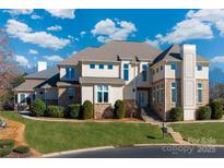 Stunning two-story home boasts a beautifully landscaped front yard and elegant architectural details at 15618 Frohock Pl, Charlotte, NC 28277
