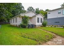 Ranch style house with a green lawn and walkway at 1726 Umstead St, Charlotte, NC 28205
