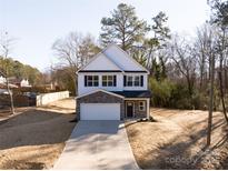 Two-story house with stone accents and a two-car garage at 2120 Golfcrest Dr, Kannapolis, NC 28081