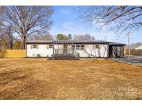 Newly renovated ranch home with a modern gray pergola and deck at 3722 Unionville Indian Trail W Rd, Indian Trail, NC 28079